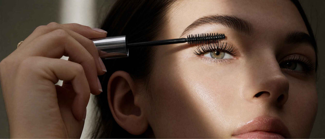 A woman applying mascara
